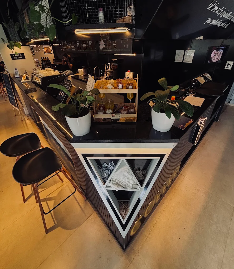 The Abrista bar from above with bar stools and pastries on display