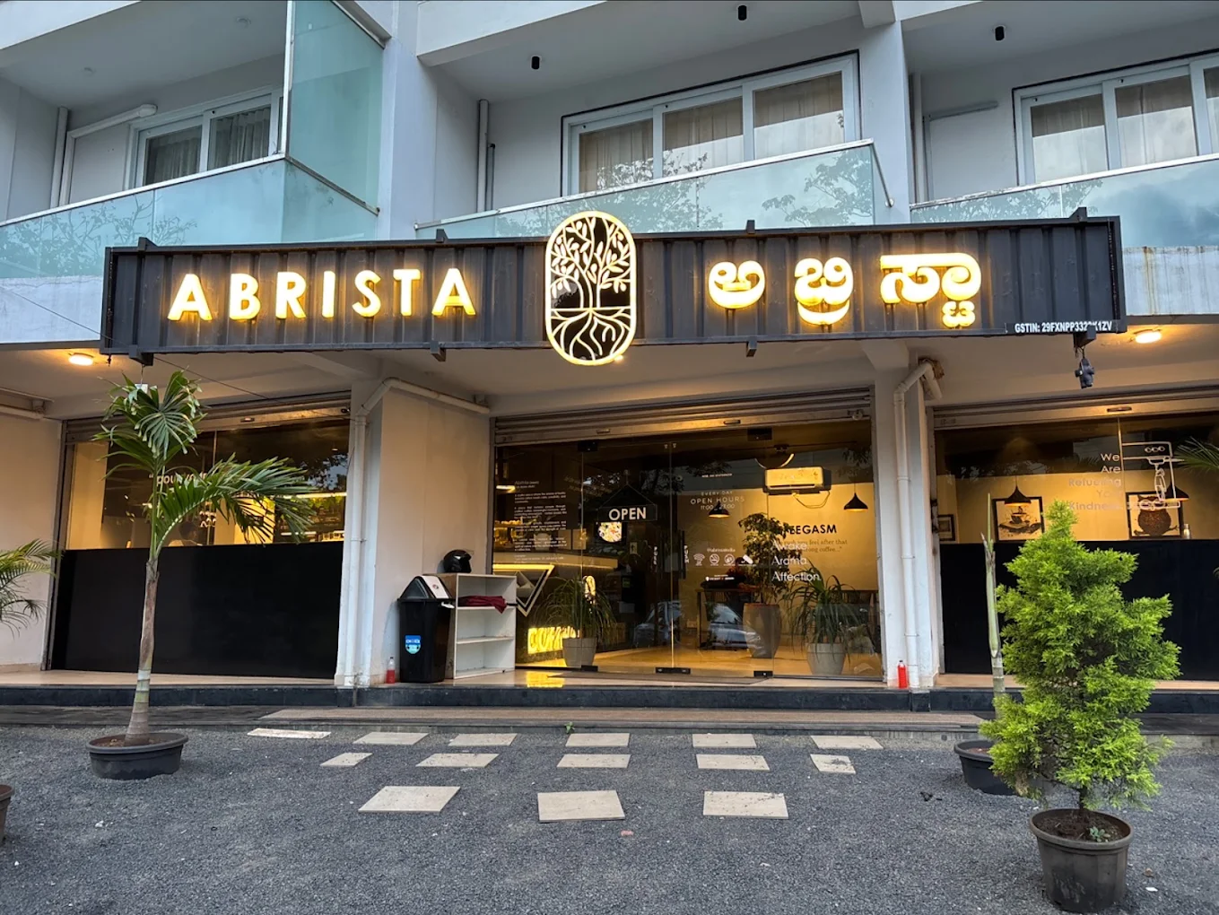 The illuminated Abrista café storefront at dusk